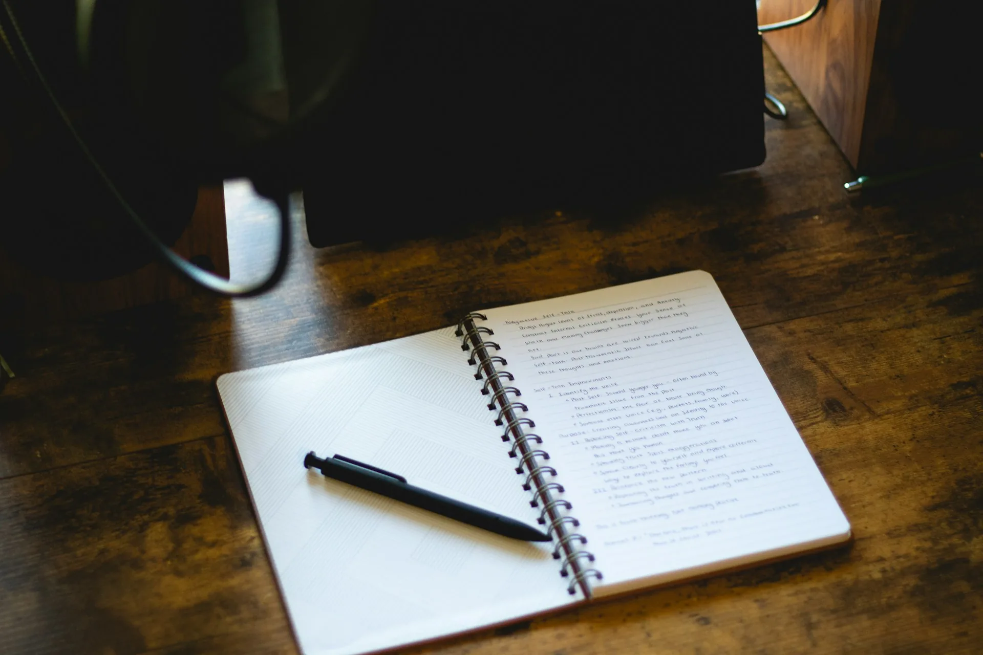 Open notebook with planning notes on a wooden table
