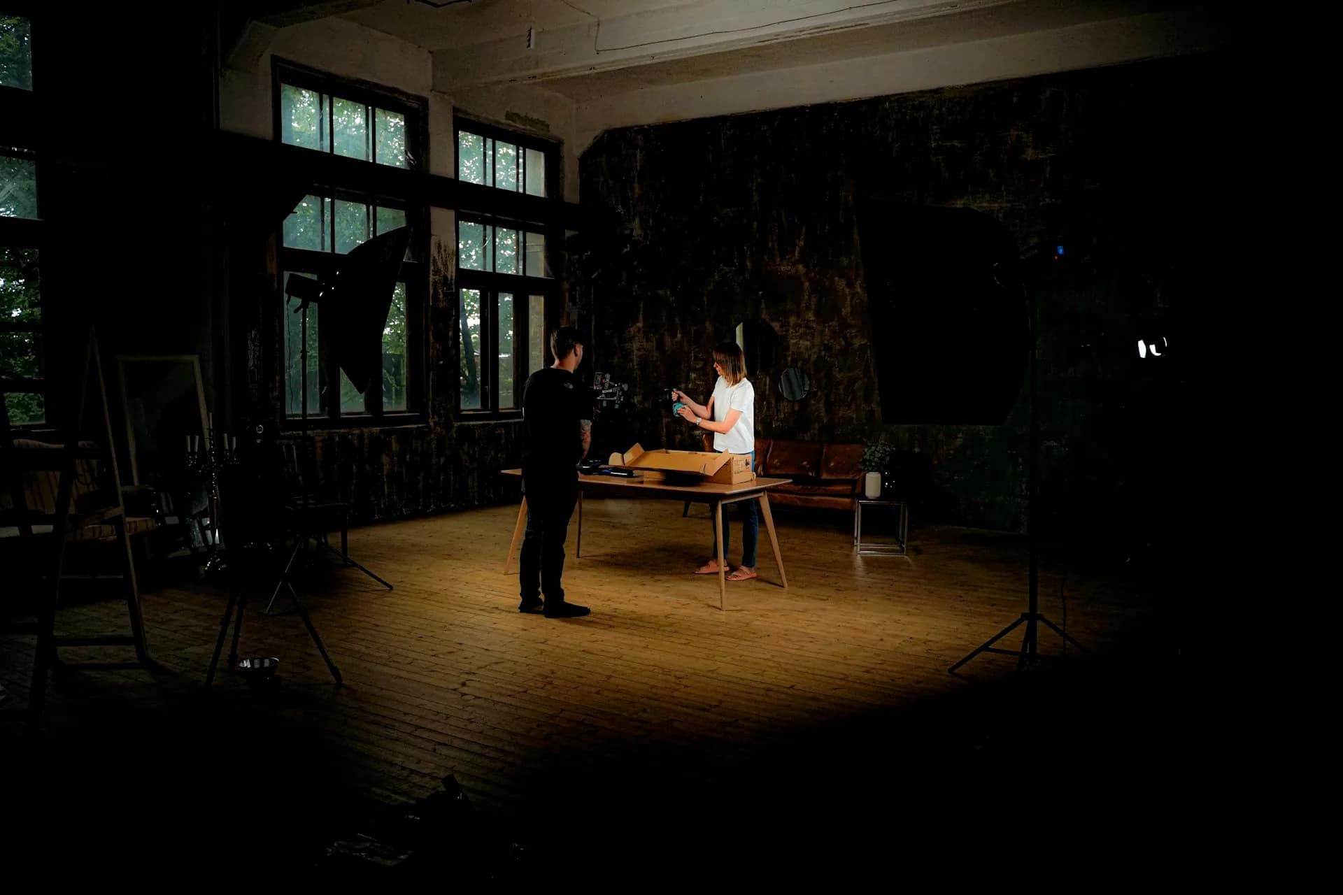 Two people in a room with studio lighting during a recording