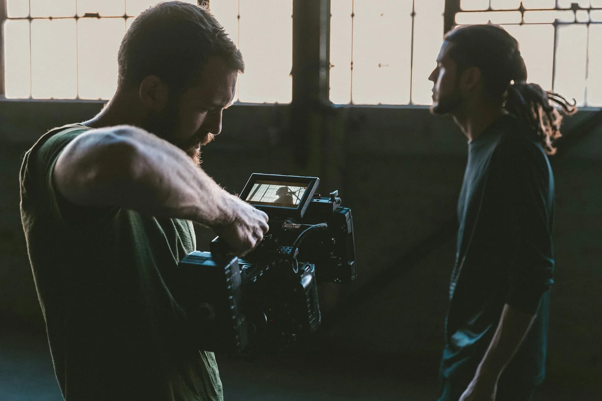 Camera operator filming a person in an indoor studio