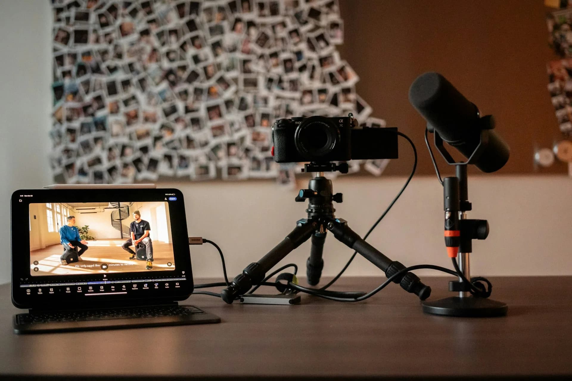 Camera, microphone and editing screen in a podcast recording setup
