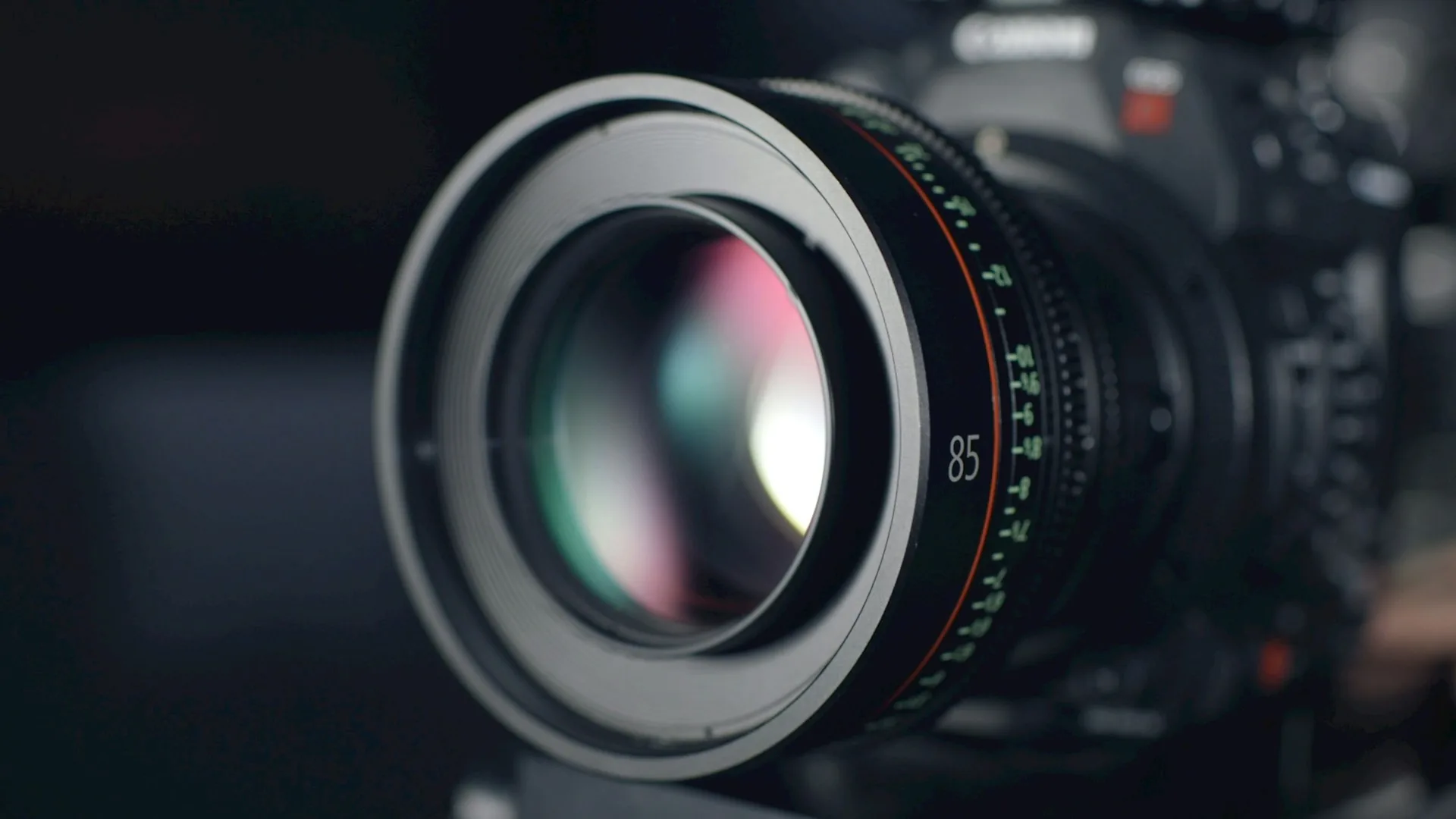 Professional video camera in focus during a talking head recording in a studio