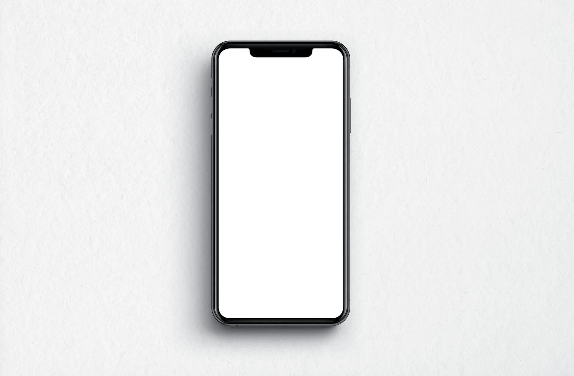 Teléfono móvil sobre una superficie mostrando pantalla en formato vertical