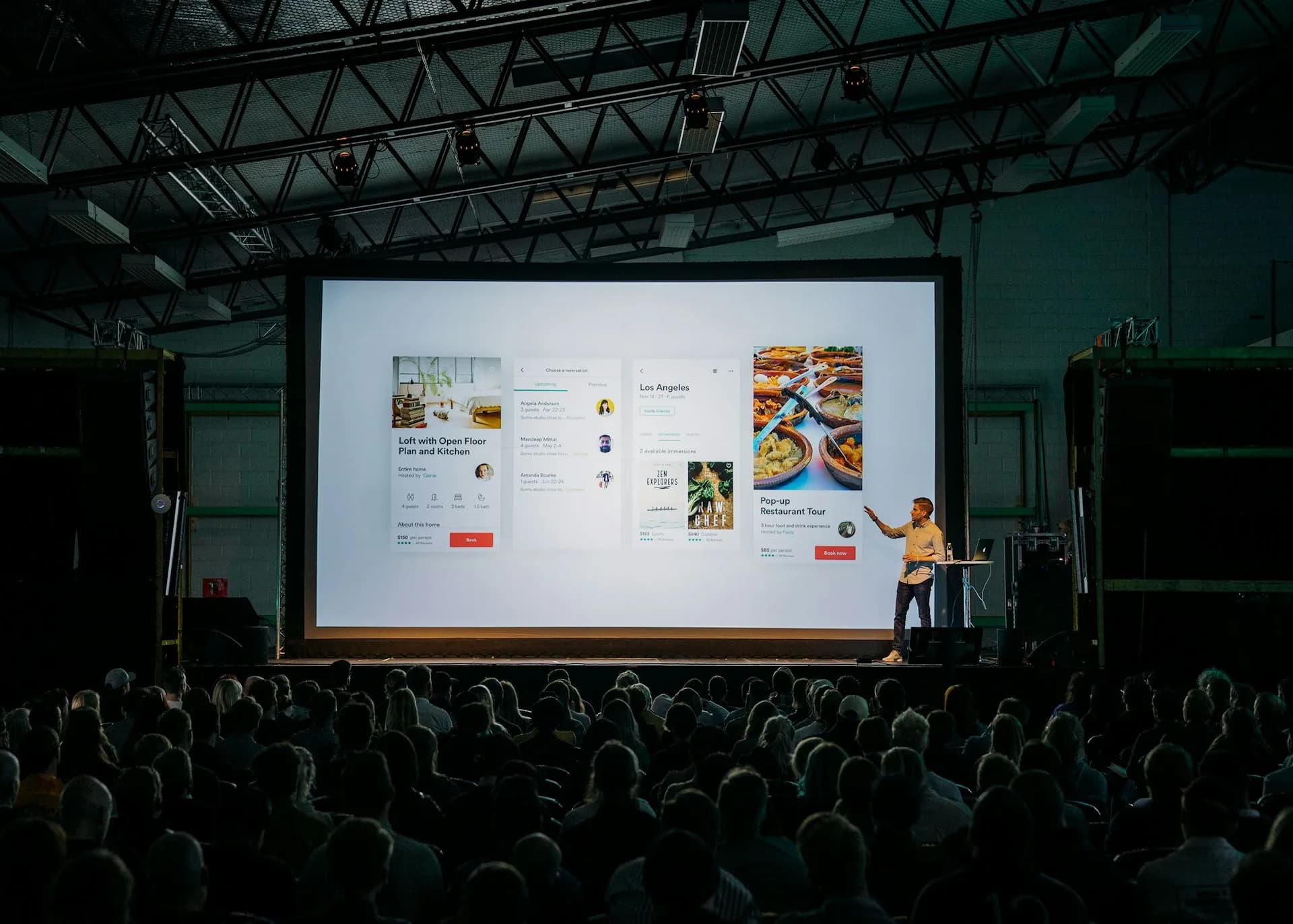 Persona presentando un pitch frente a una pantalla ante una sala